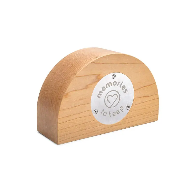 Wooden semicircular Rainbow urn by Memories to Keep, shown at an angle, back view with a round metal plate engraved with “memories to keep” and a heart logo.